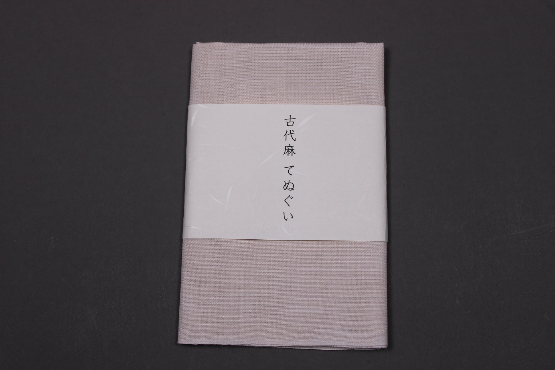 okai mafu linen towel tenugui neatly folded wrapped with fine paper showcasing company name
