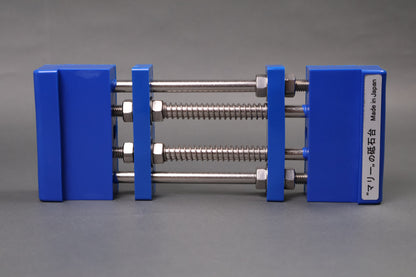 marie whetstone holder red rectangular shaped on its side showing blue pvc body stainless steel rods springs grey backdrop