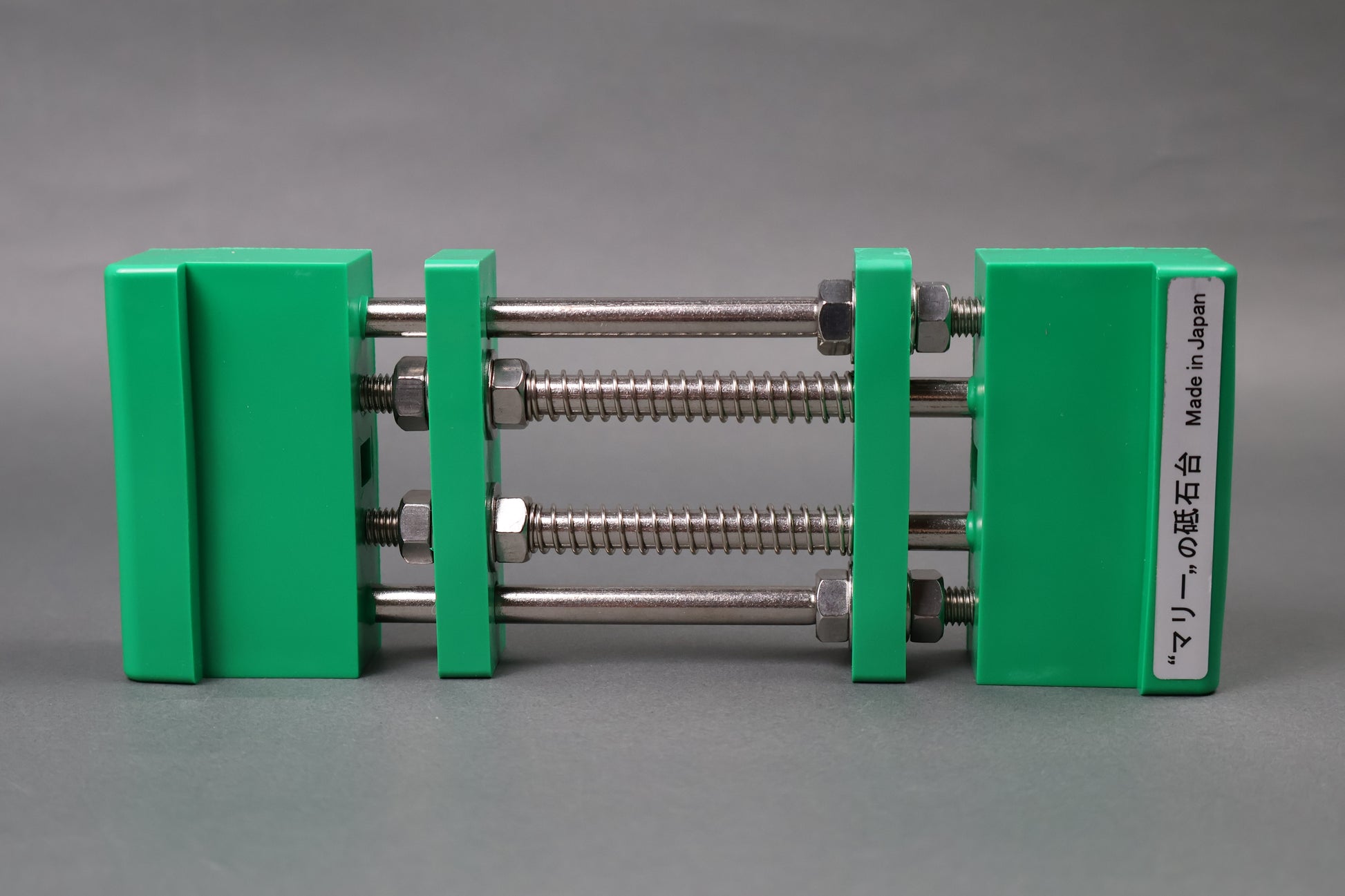 marie whetstone holder red rectangular shaped on its side showing green pvc body stainless steel rods springs grey backdrop