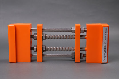 marie whetstone holder red rectangular shaped on its side showing orange pvc body stainless steel rods springs grey backdrop
