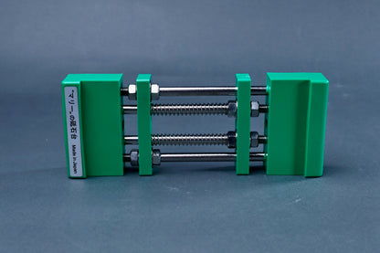Marie's stone holder green front view showing dual spring screw mechanism and Made in Japan label on grey background