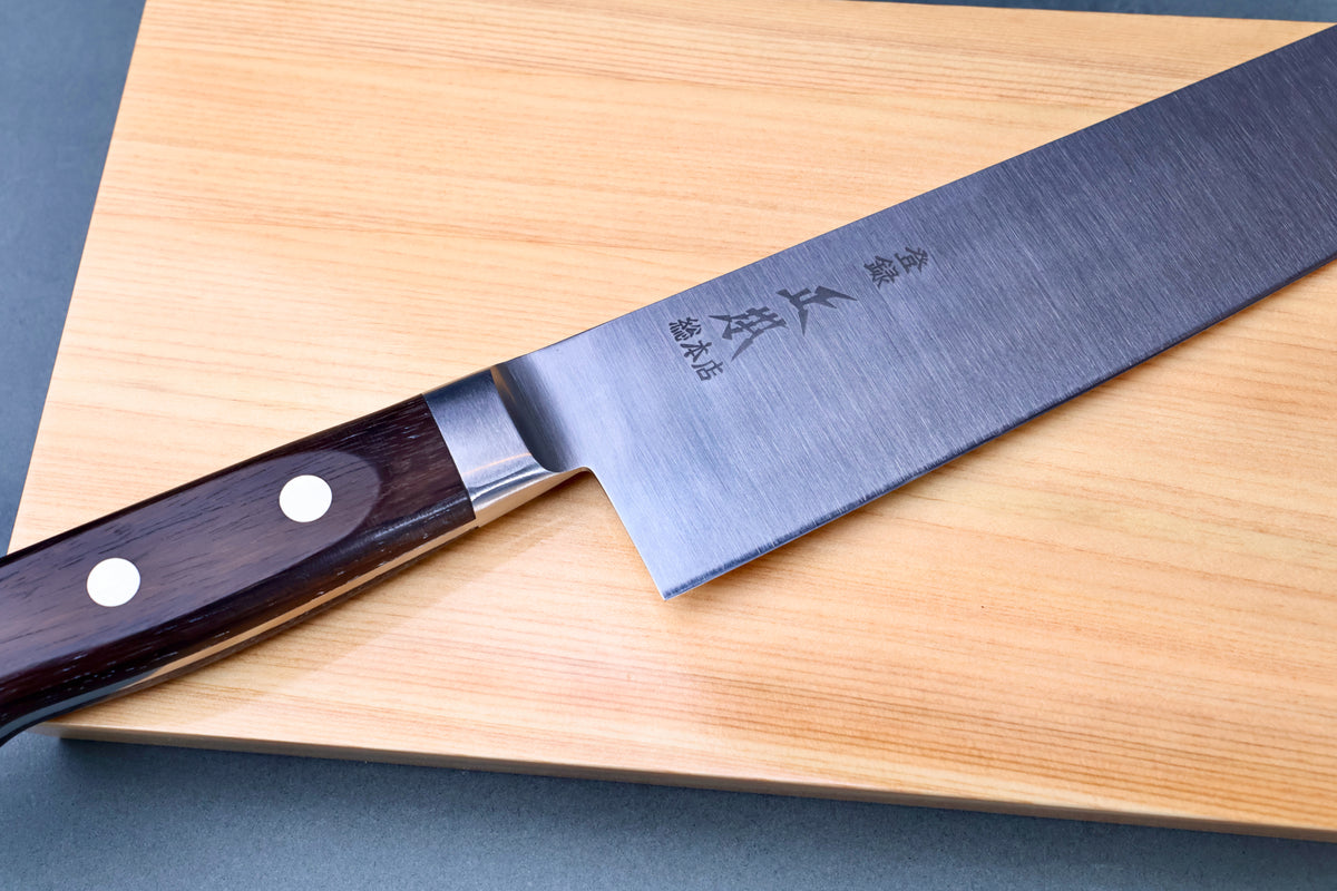 Masamoto CT carbon steel gyuto 240mm handle and blade junction on hinoki cutting board