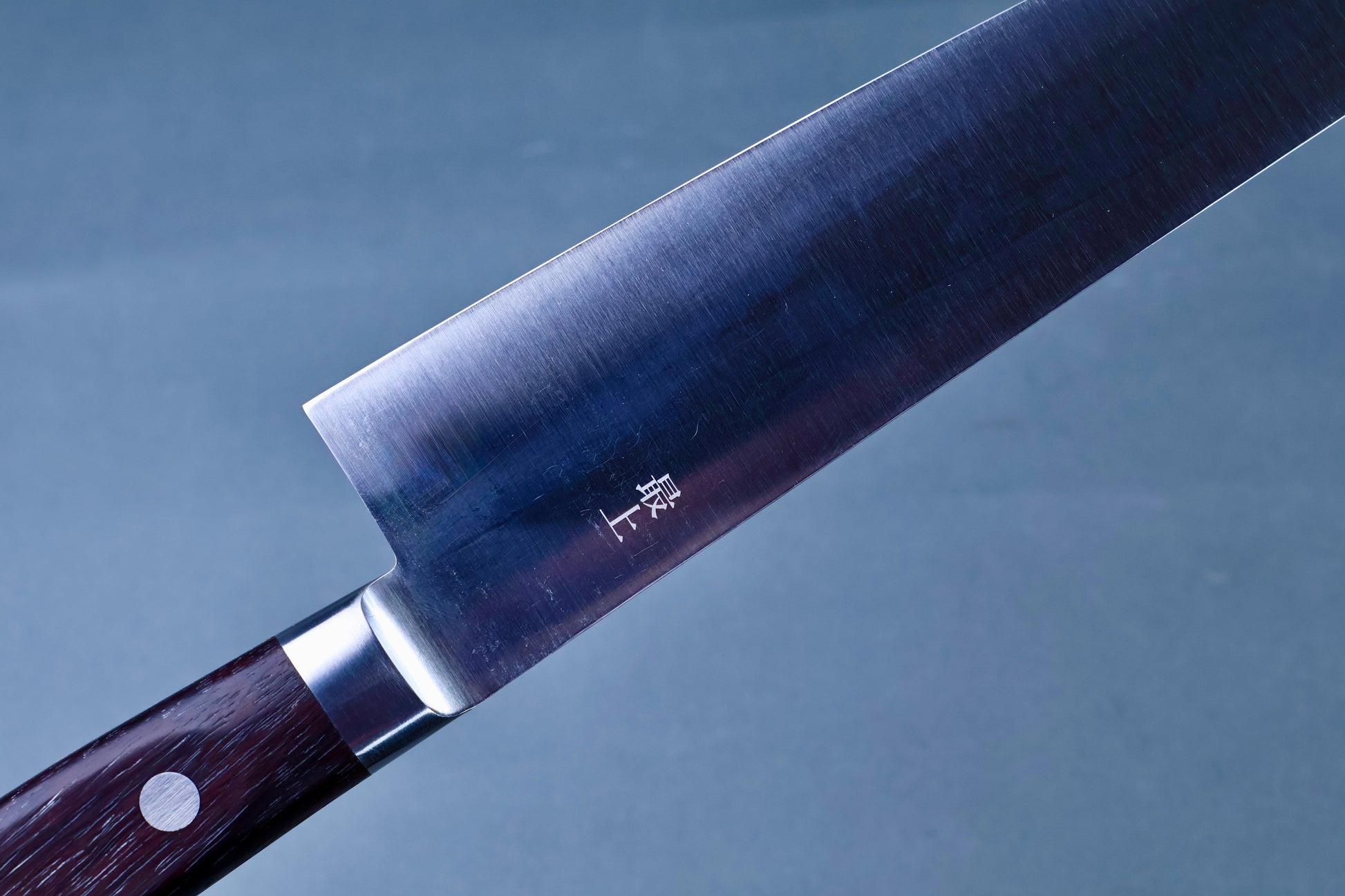Masamoto CT carbon steel gyuto 240mm heel detail showing kanji engraving and stainless bolster