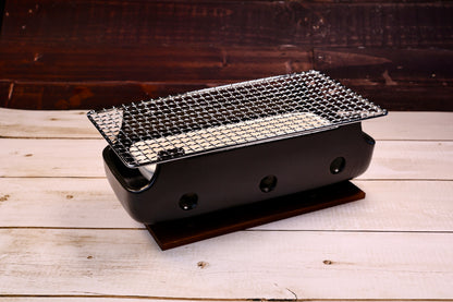 Misuzu Pottery Banko Yaki Konro Grill, low angled view showing ceramic body curve, side handles, and wood trivet base