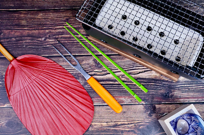 Misuzu Pottery Banko Yaki Konro Grill, overhead flat lay on dark wood with Japanese fan, chopsticks, and tableware
