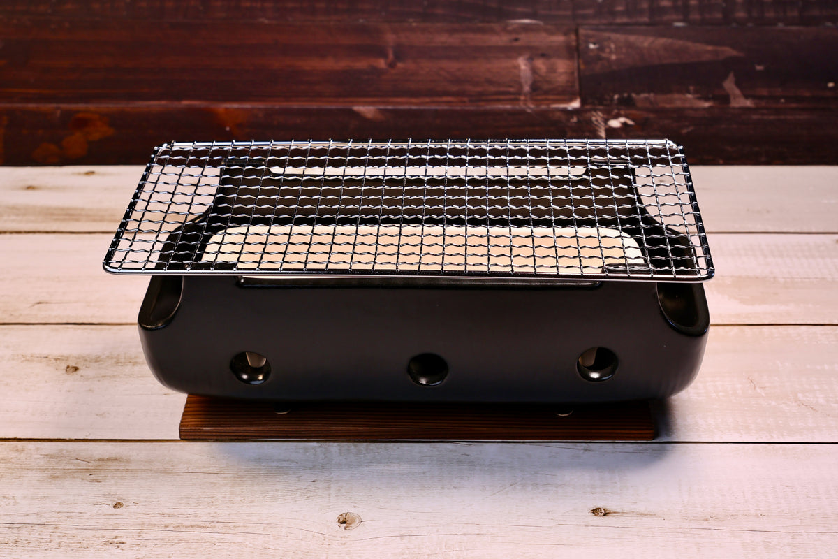 Misuzu Pottery Banko Yaki Konro Grill, assembled front view on wood plank showing full ceramic body and stainless grate