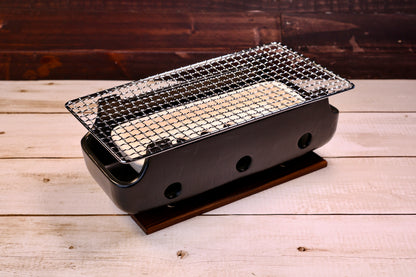 Misuzu Pottery Banko Yaki Konro Grill, three-quarter angled view showing black ceramic body, wire grate, and wood base