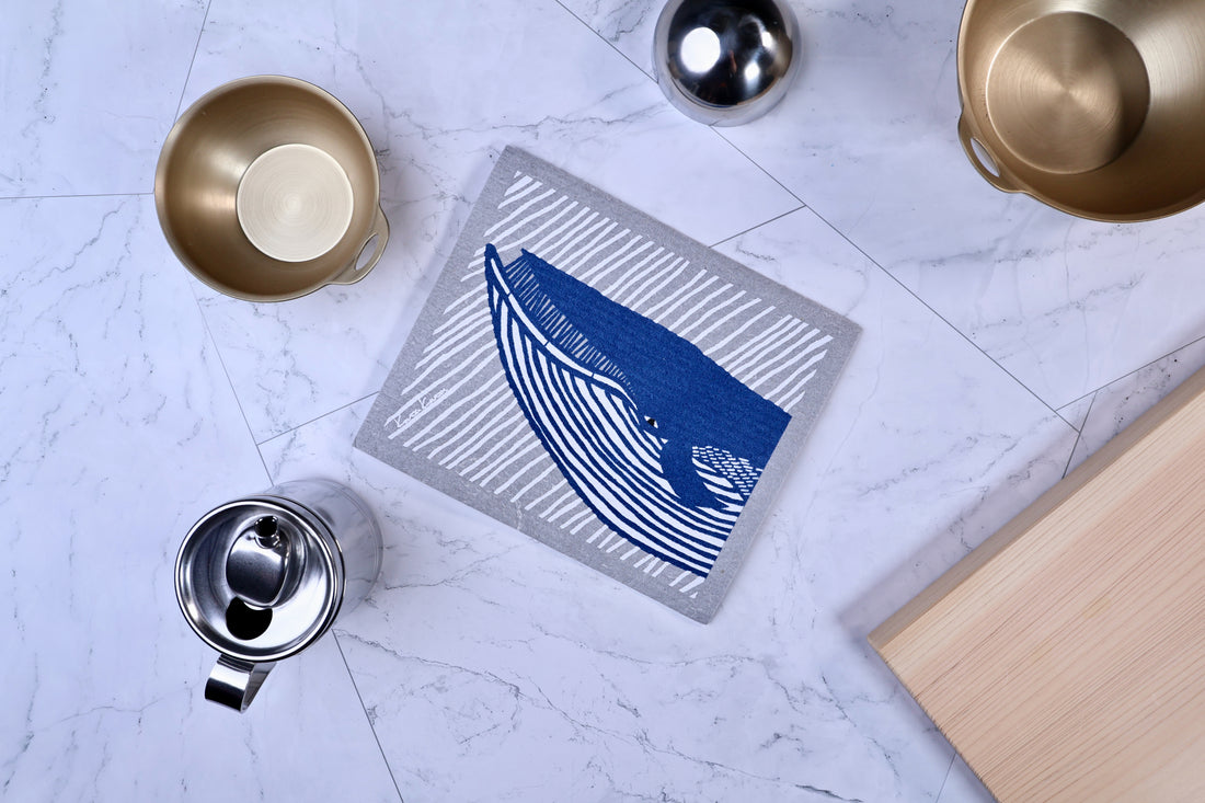 Morikatsu Katakata whale towel folded on marble surrounded by kitchen cookware, showing real-use context