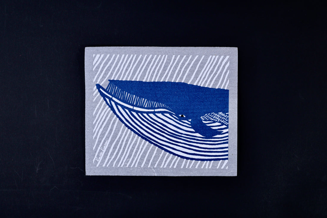 Morikatsu Katakata whale towel flat on black background, full blue whale design on gray ground with artist signature