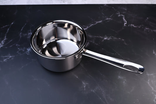 Mt. Fuji Steel Clad saucepan 16cm without lid showing polished stainless interior and loop handle on marble