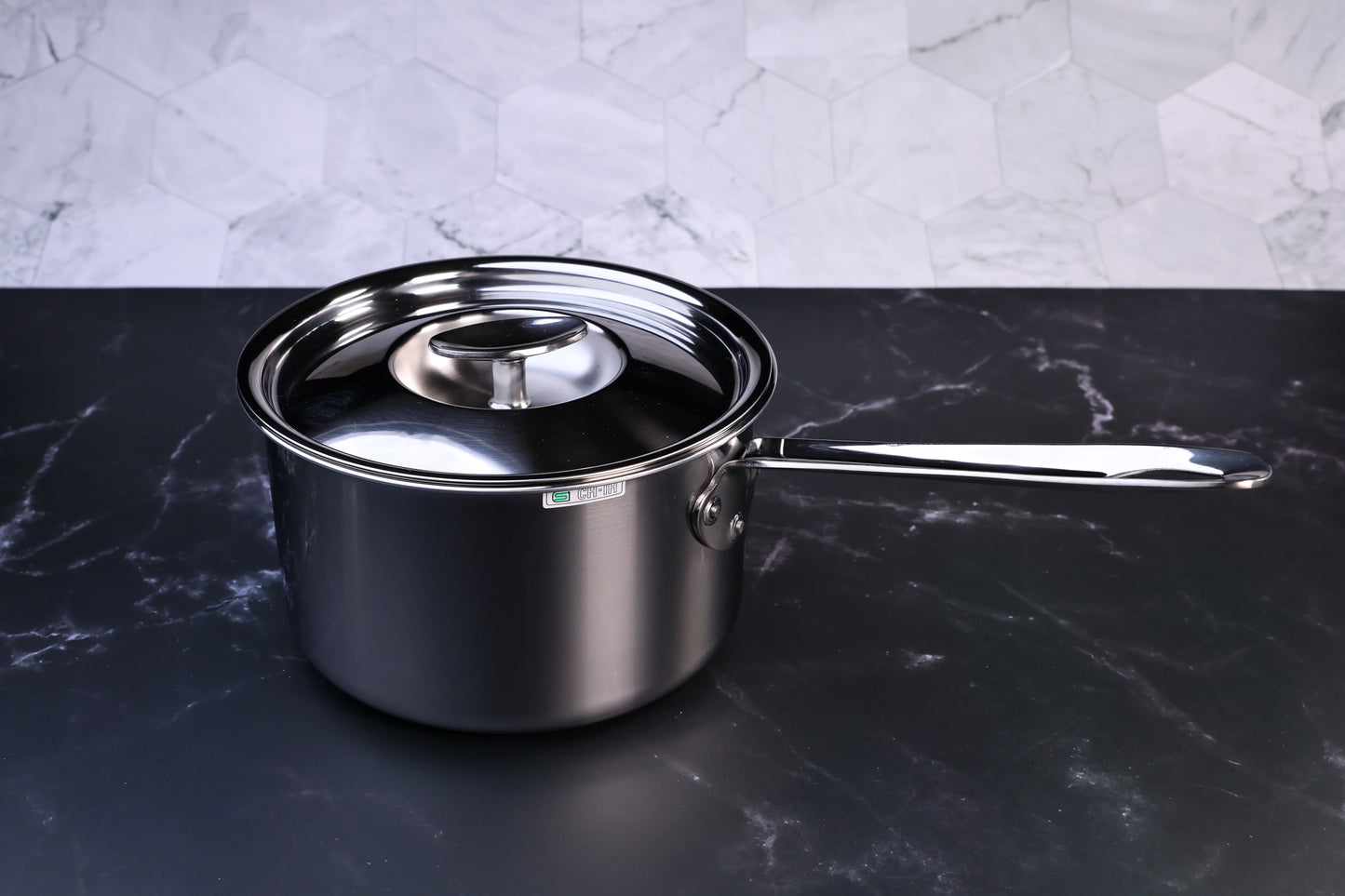 Mt. Fuji Steel Clad saucepan 18cm with stainless lid on black marble and white tile background