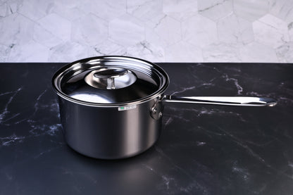 Mt. Fuji Steel Clad saucepan 18cm with stainless lid on black marble and white tile background