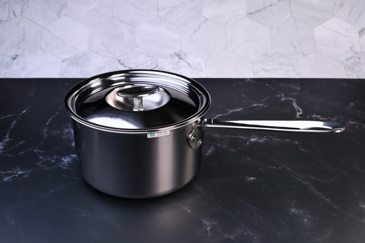 Mt. Fuji Steel Clad saucepan 18cm with stainless lid on black marble and white tile background