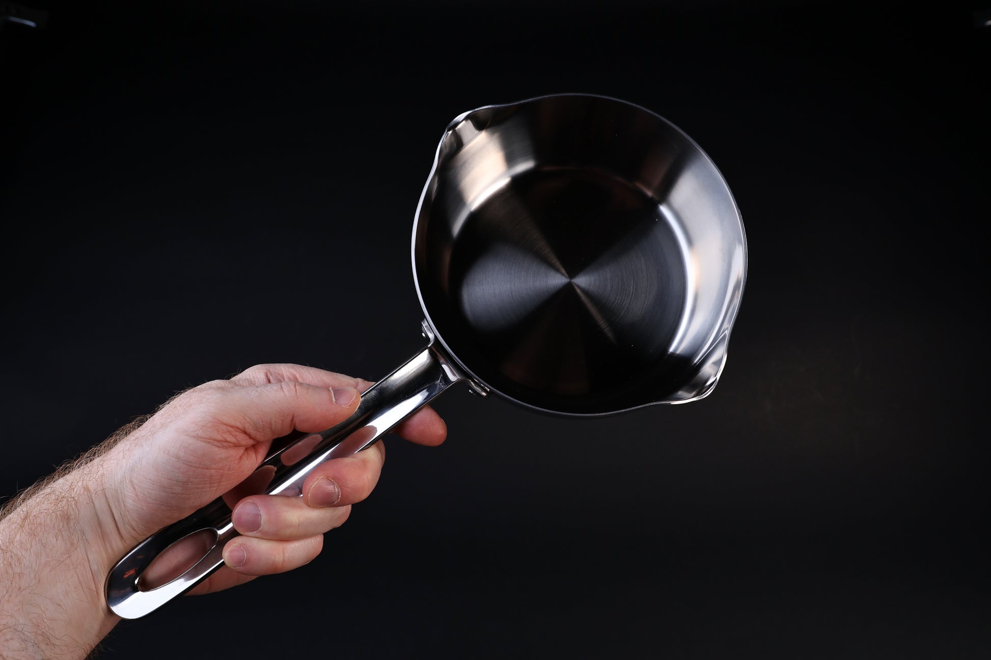 Mt. Fuji Steel Clad Yukihira saucepan 18cm held in hand showing size, interior, and pour spout detail