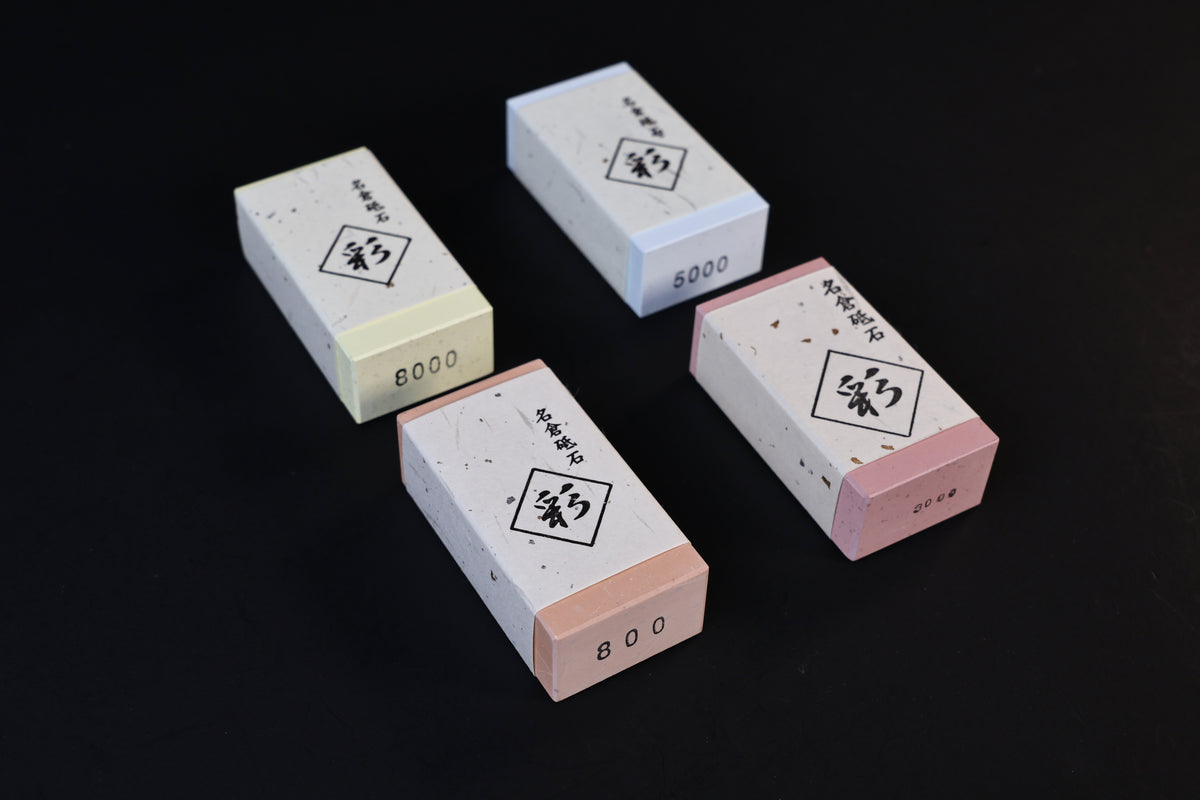 Four Naniwa Nagura stones arranged on black background showing 800, 5000, and 8000 grit numbers on ends