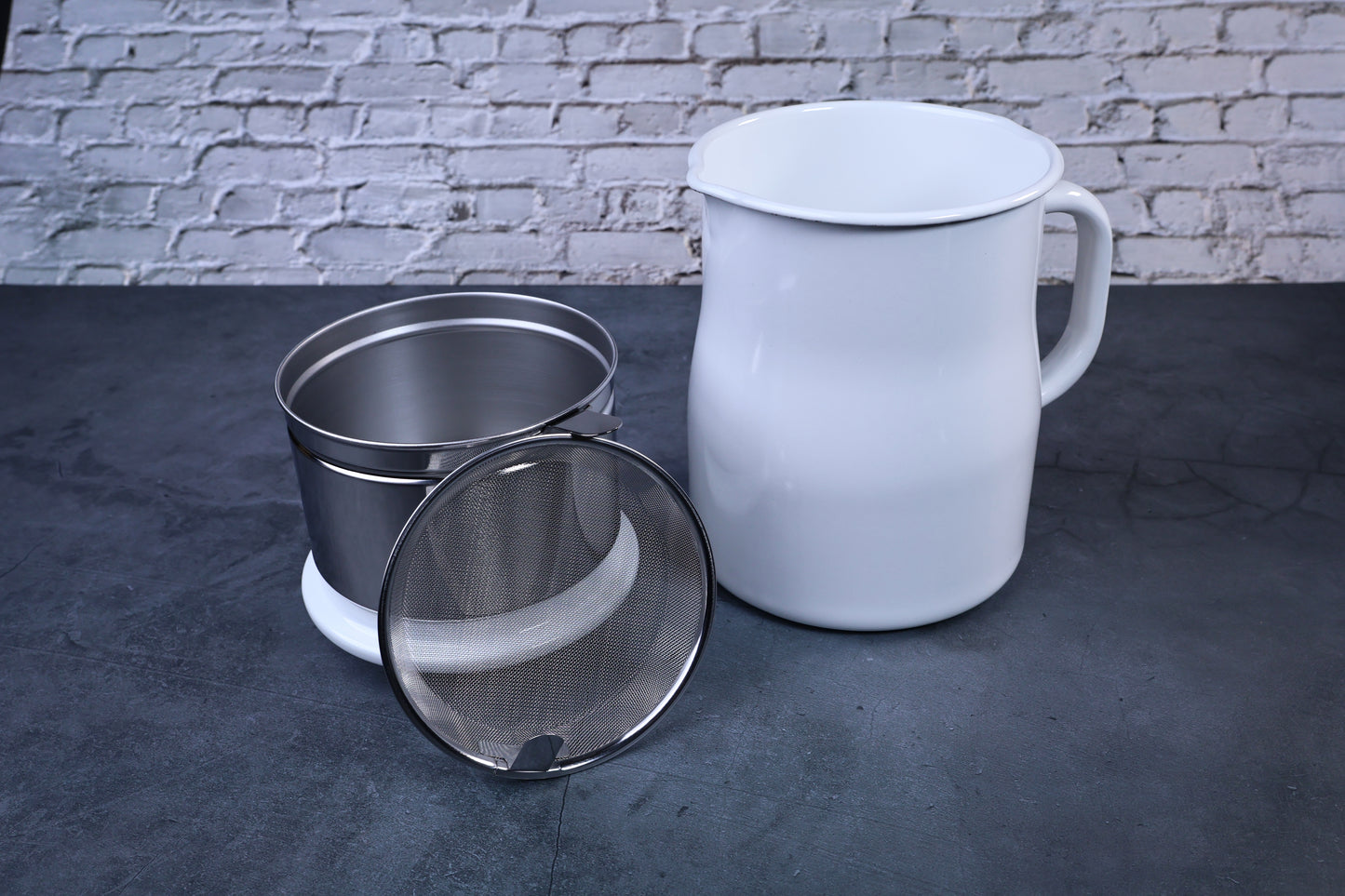 Noda Horo enamel oil pot — disassembled showing enamel pot, stainless inner pot, and mesh filter strainer
