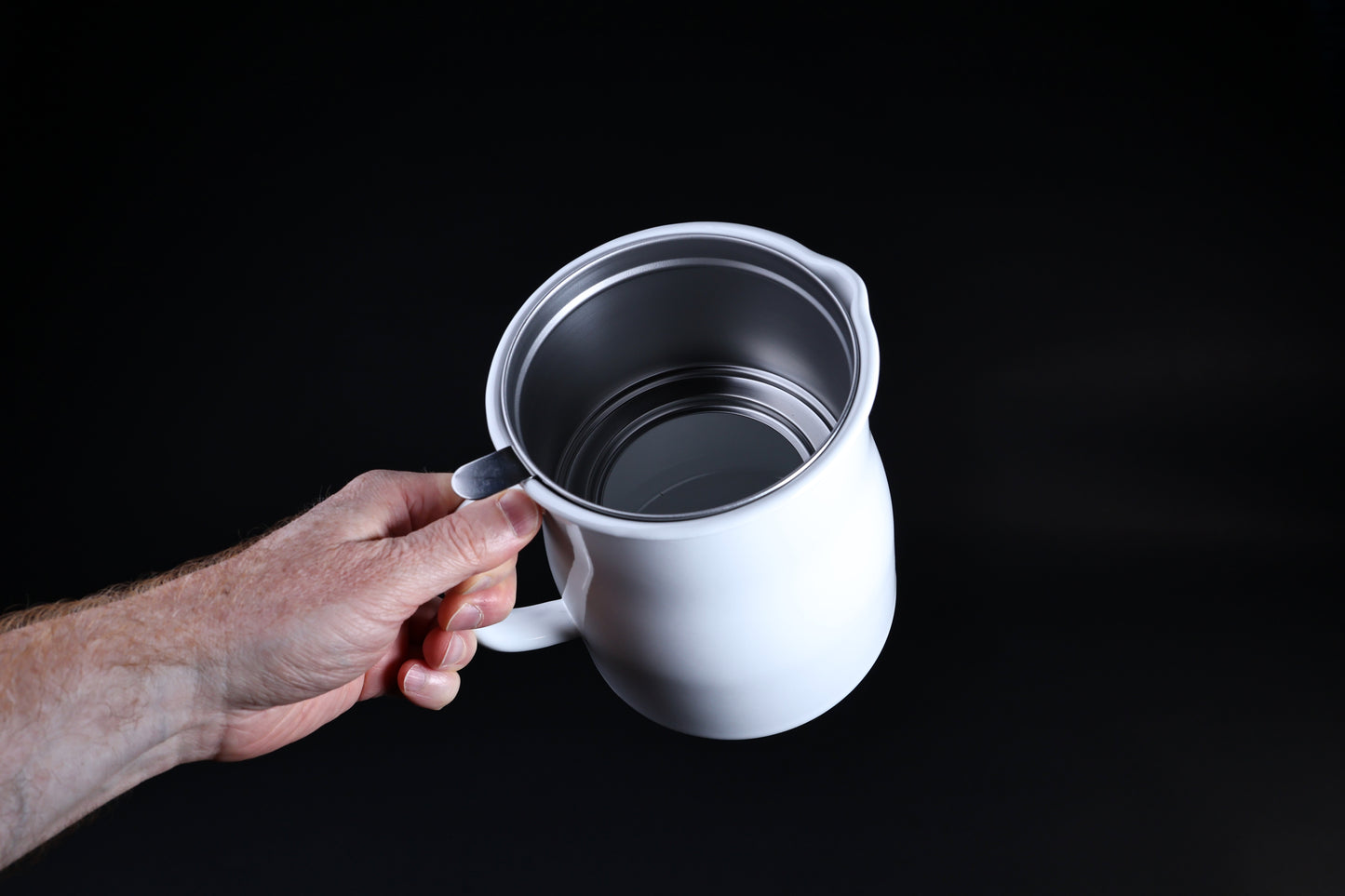 Noda Horo enamel oil pot — held open showing stainless inner pot interior and enamel rim detail