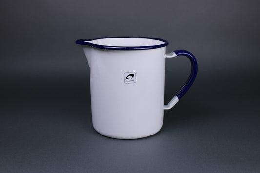 frontal image of white glazed and blue trimmed noda horo pitcher with curved rim to allow easy pouring and a stout handle with a grey background