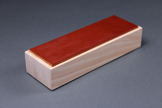 Ochre Hinoki Leather Knife Strop — close-up of ochre leather surface and hinoki wood grain at corner