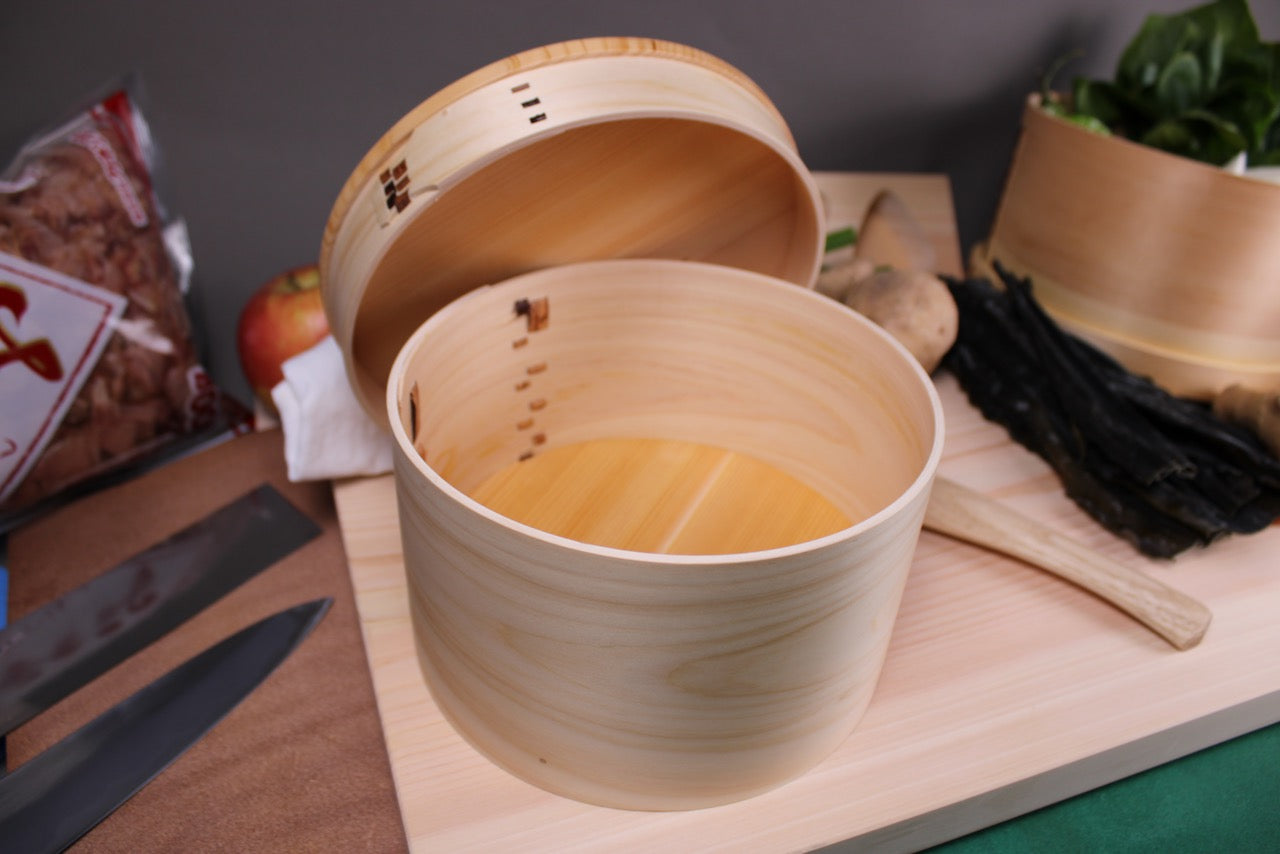 kiso sawara hinoki wood rice chest 6 cup handmade with lid beside atop cutting board rice scoop and sarashi towel japanese kitchenware 