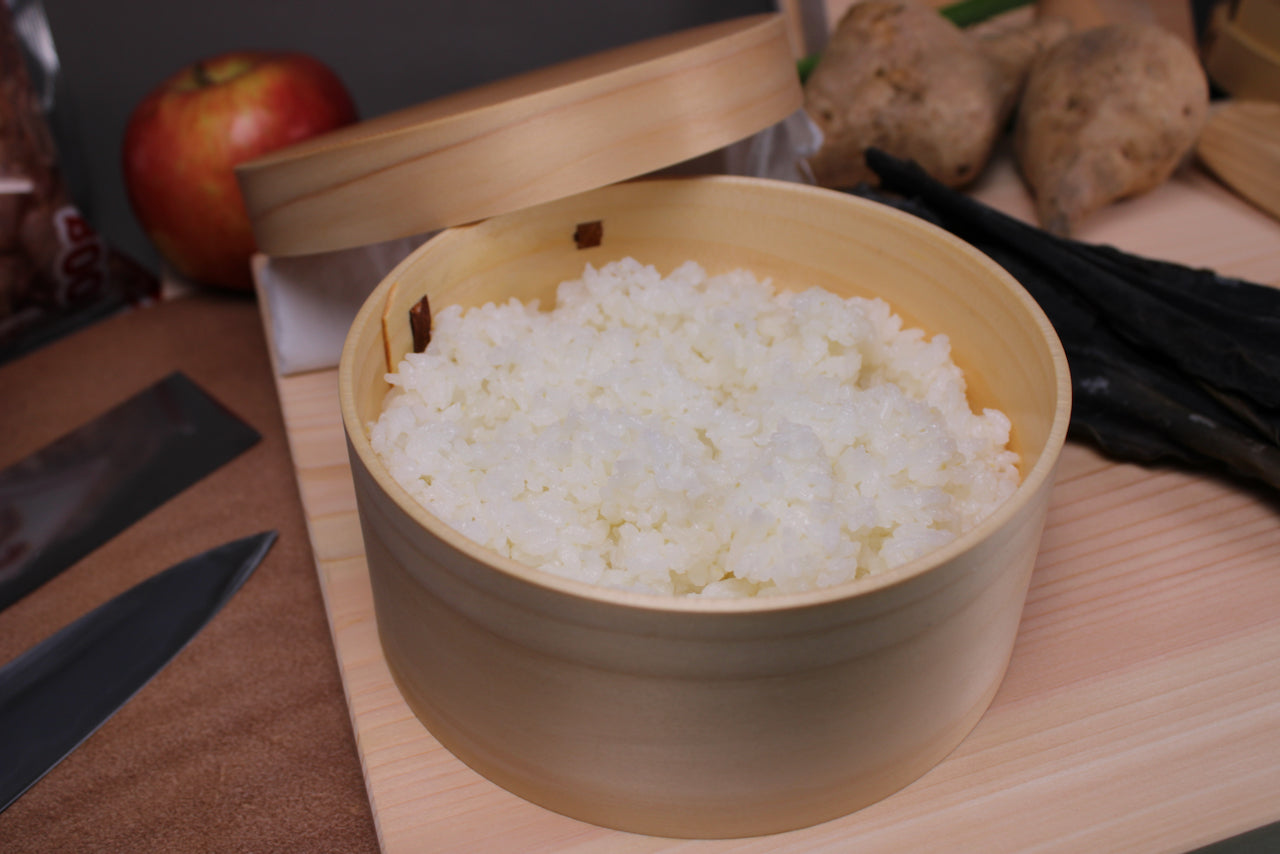 top view s cup ohitsu rice chest with lid beside interior freshly prepared rice background of hinoki cutting board japanese kitchenware 