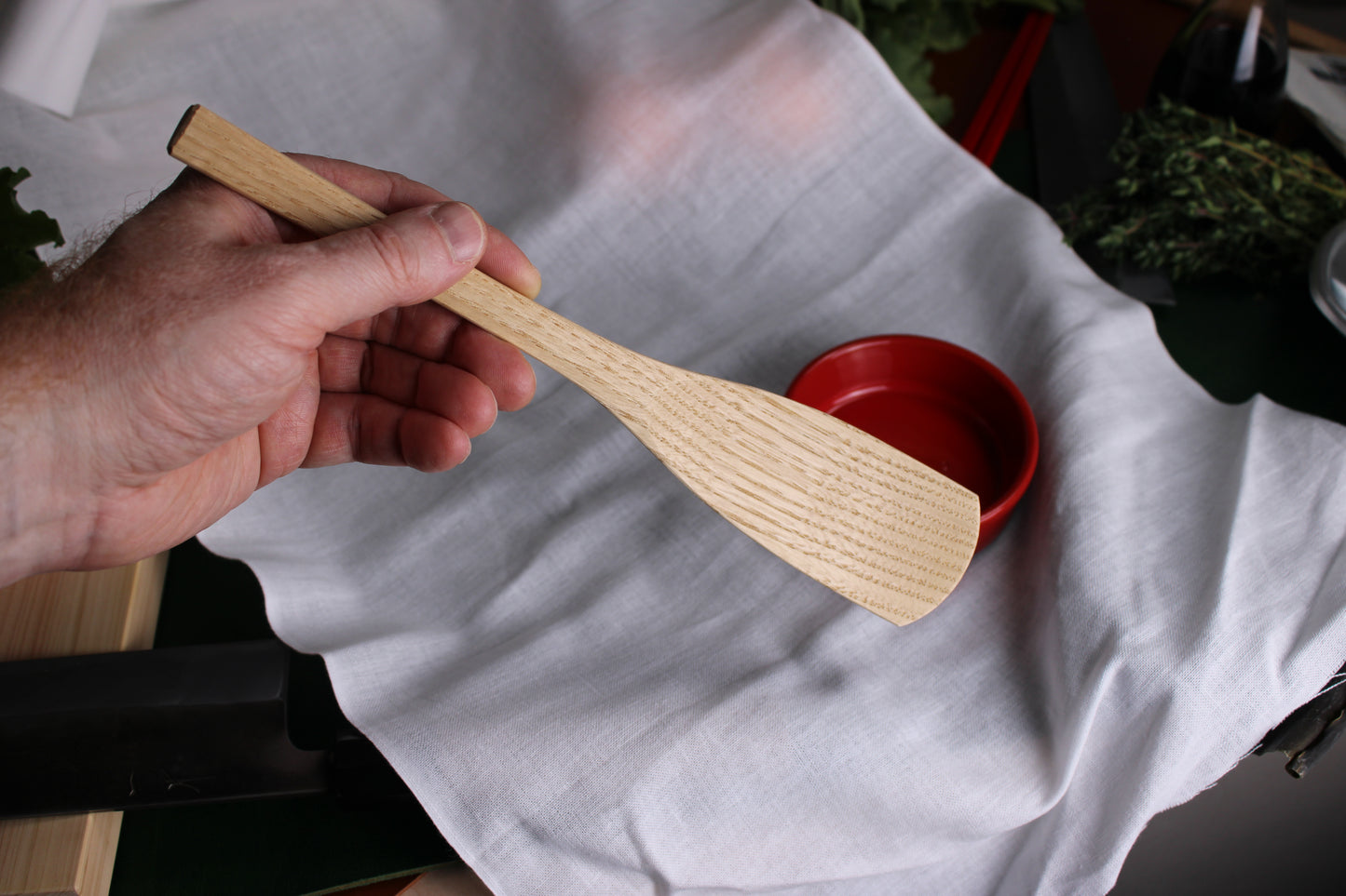 holding okubo house artisan cooking spoon chestnut japanese kitchenware white background