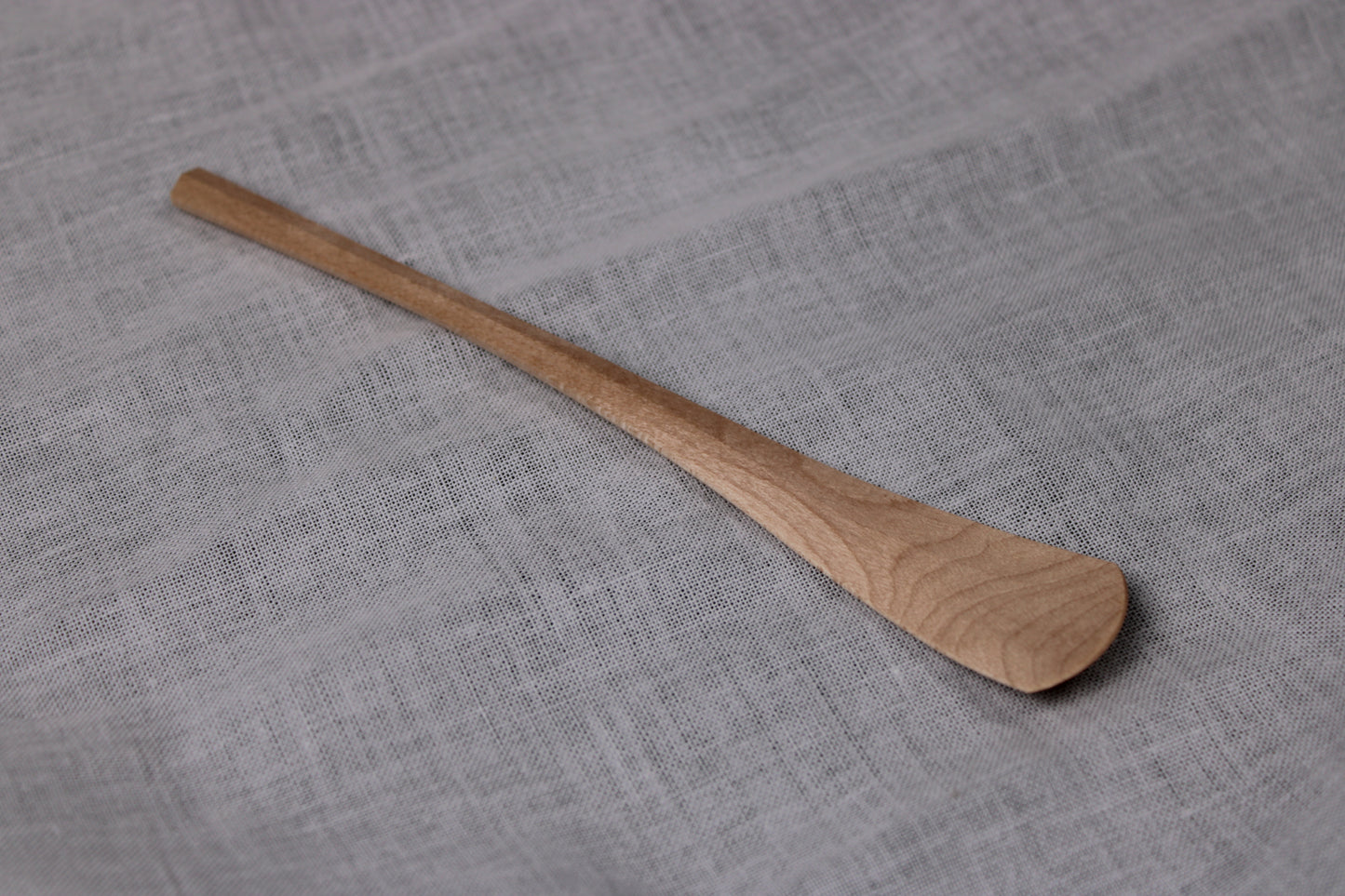 okubo house handmade artisan maple wood spoon made without sanding or filing layed flat with white background