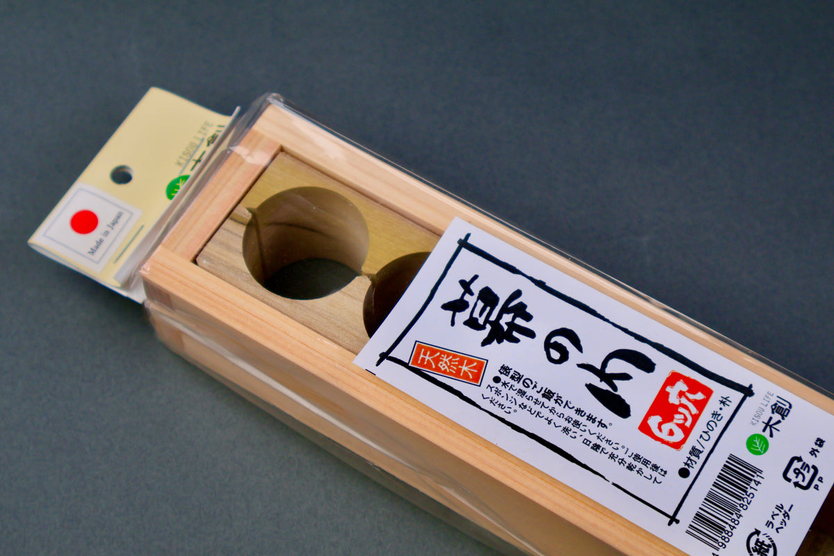 detail of long rectangular bale shaped six hole onigiri mold in plastic packaging with youbi label on dark grey background