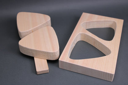 rectangular light tan hinoki wood onigiri maker two large triangles horizontal connecting wood nailed in place in dark backdrop