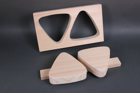 rectangular light tan hinoki wood onigiri maker two large triangles horizontal connecting wood nailed in place in dark backdrop