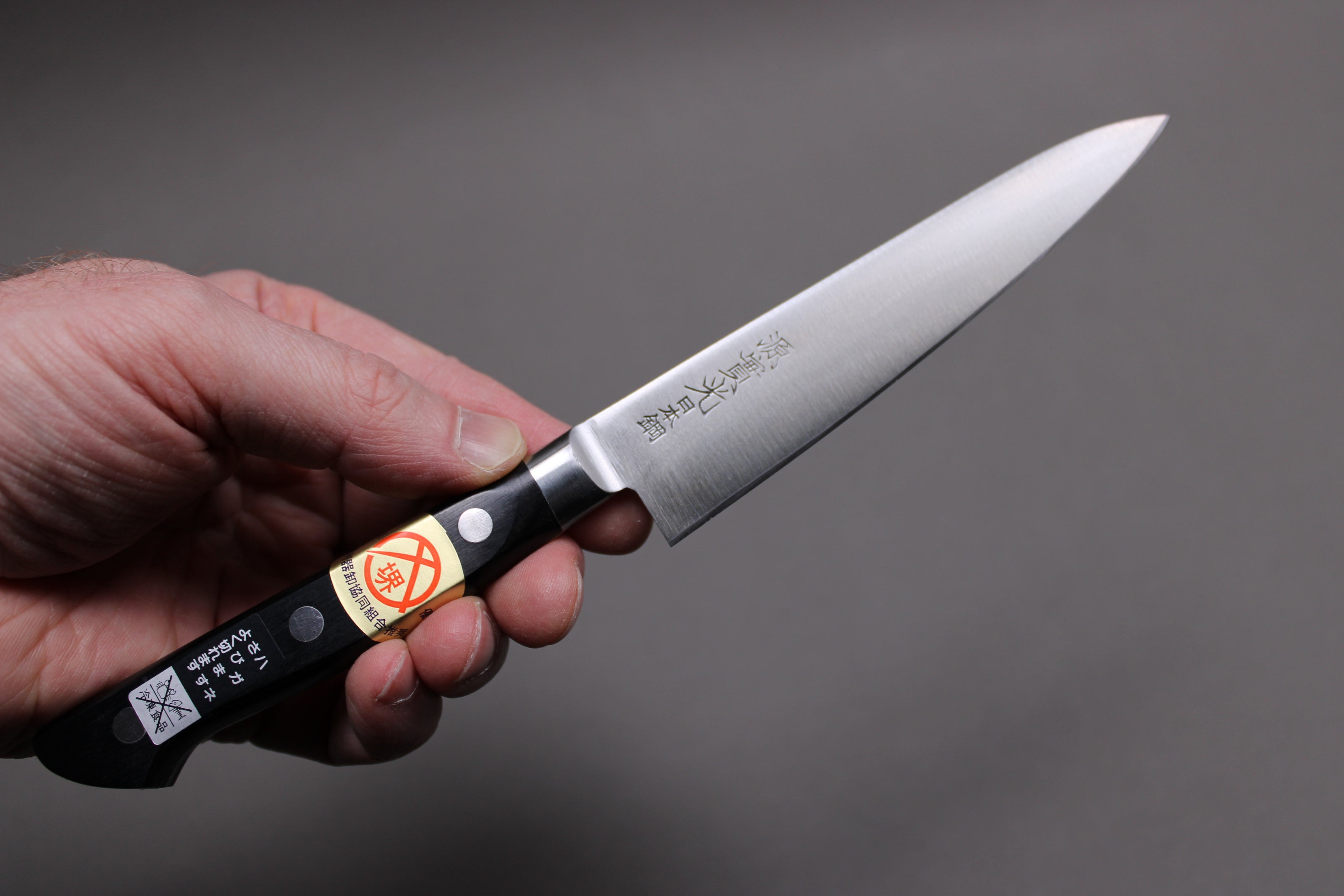  hand holding 120mm carbon steel petty