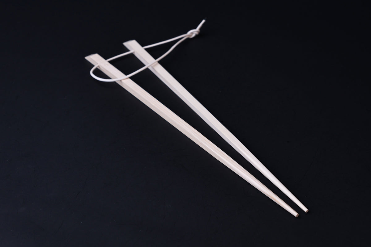 Saibashi square cooking chopsticks — full length angled view, tip end down showing taper to fine point