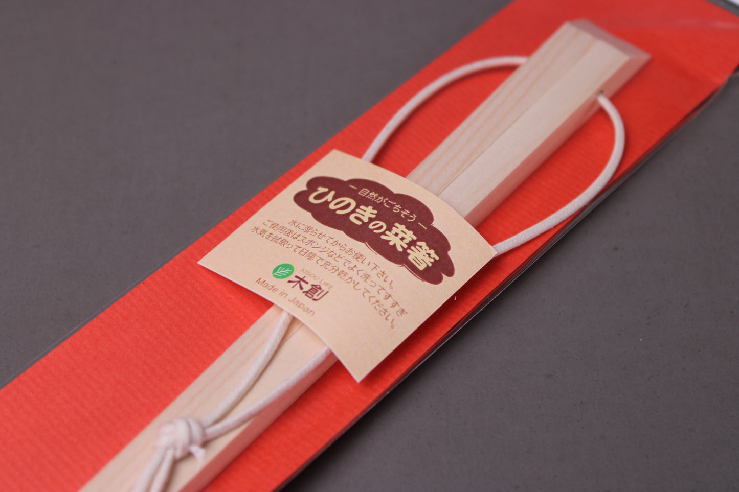 saibashi square cooking chopsticks by yamacoh youbi kisou life packed in clear plastic with red paper backing and sticker writing hinoki in hiragana with grey background closeup of top of package