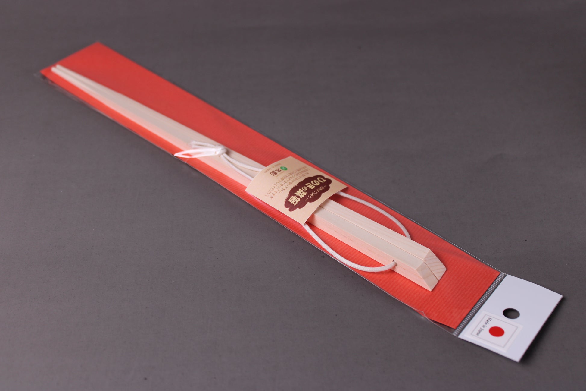  saibashi square cooking chopsticks by yamacoh youbi kisou life packed in clear plastic with red paper backing and sticker writing hinoki in hiragana with grey background closeup of package