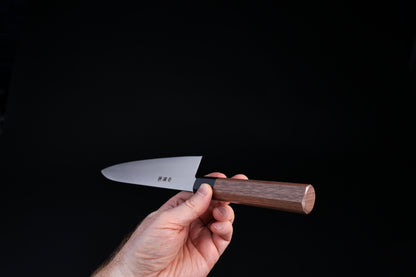 Sakai Kikumori Wasiki gyuto 210mm — choil-forward view showing blade height and octagonal walnut handle end