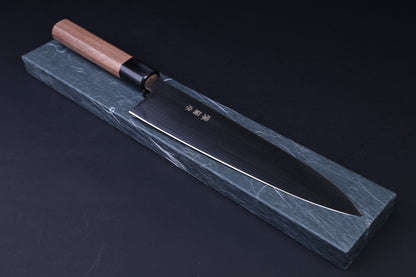 Sakai Kikumori Wasiki gyuto 210mm — resting on traditional Japanese knife box, blade and handle side view