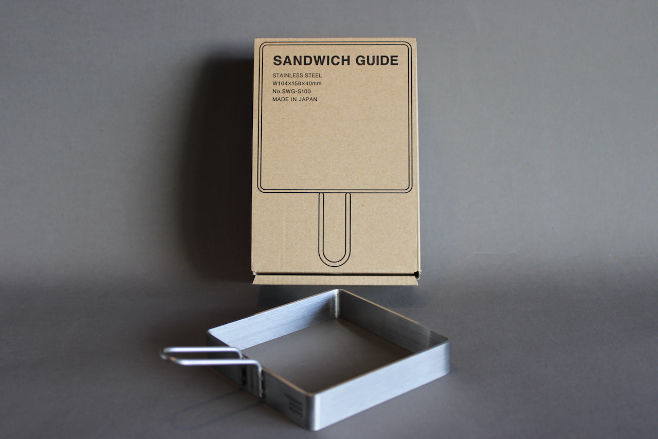 sandwich guide by yamasaki design works showing brown package box with black print and stainless steel sandwich guide with handle and logo print
