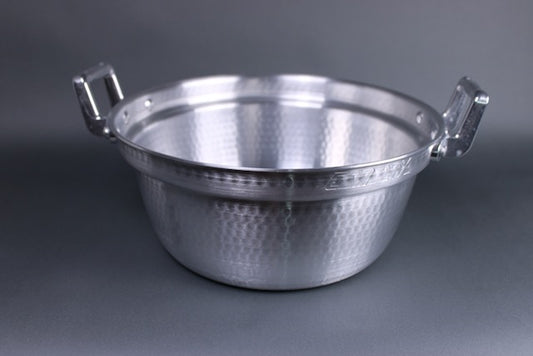 top view shot dantsuki seiro pot twenty seven cm two handled hammer tone shiny silver aluminum surface with interior ledge for steaming basket with grey background