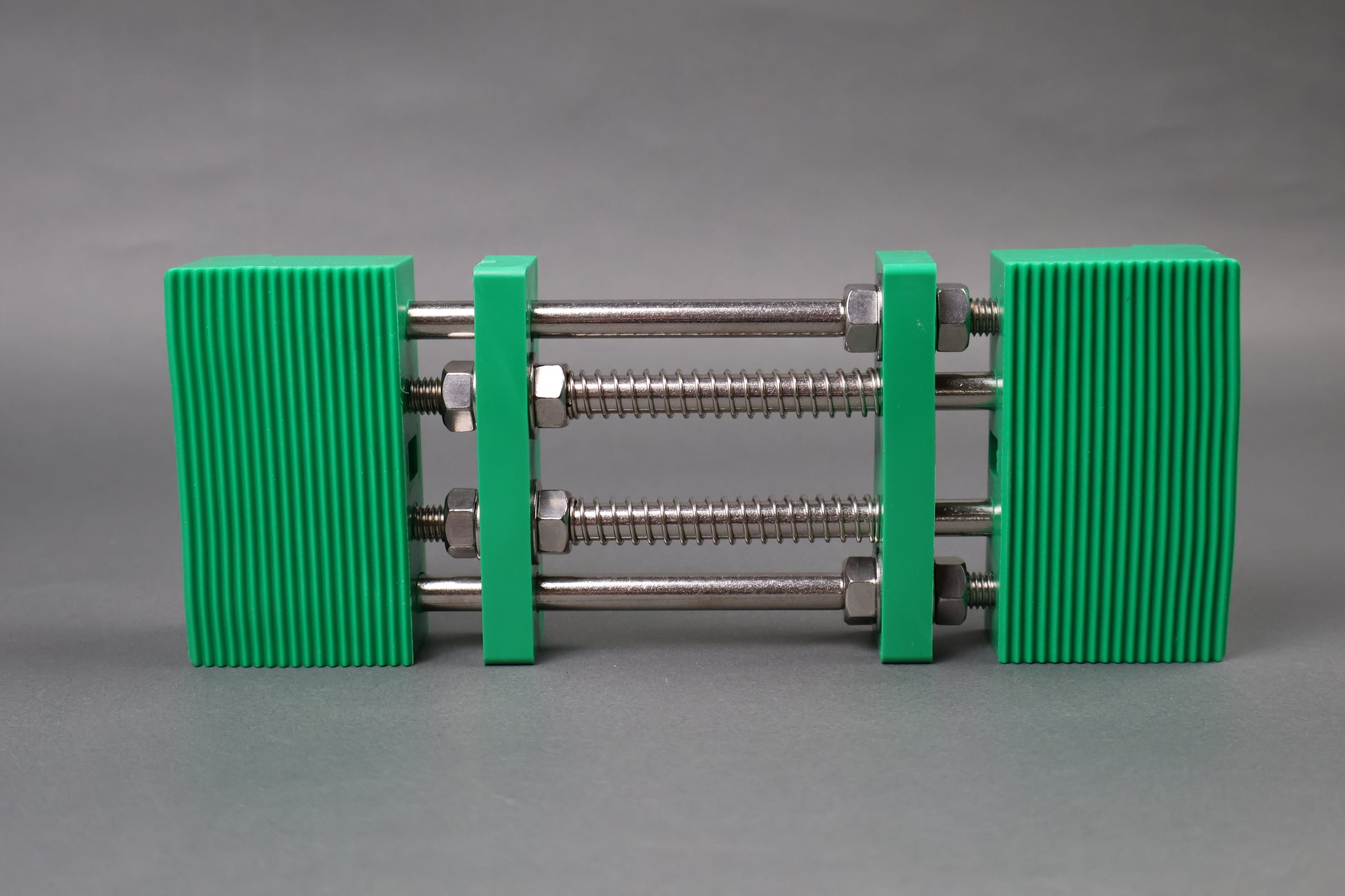 marie whetstone holder rectangular shape green in color with internal metal springs in grey background