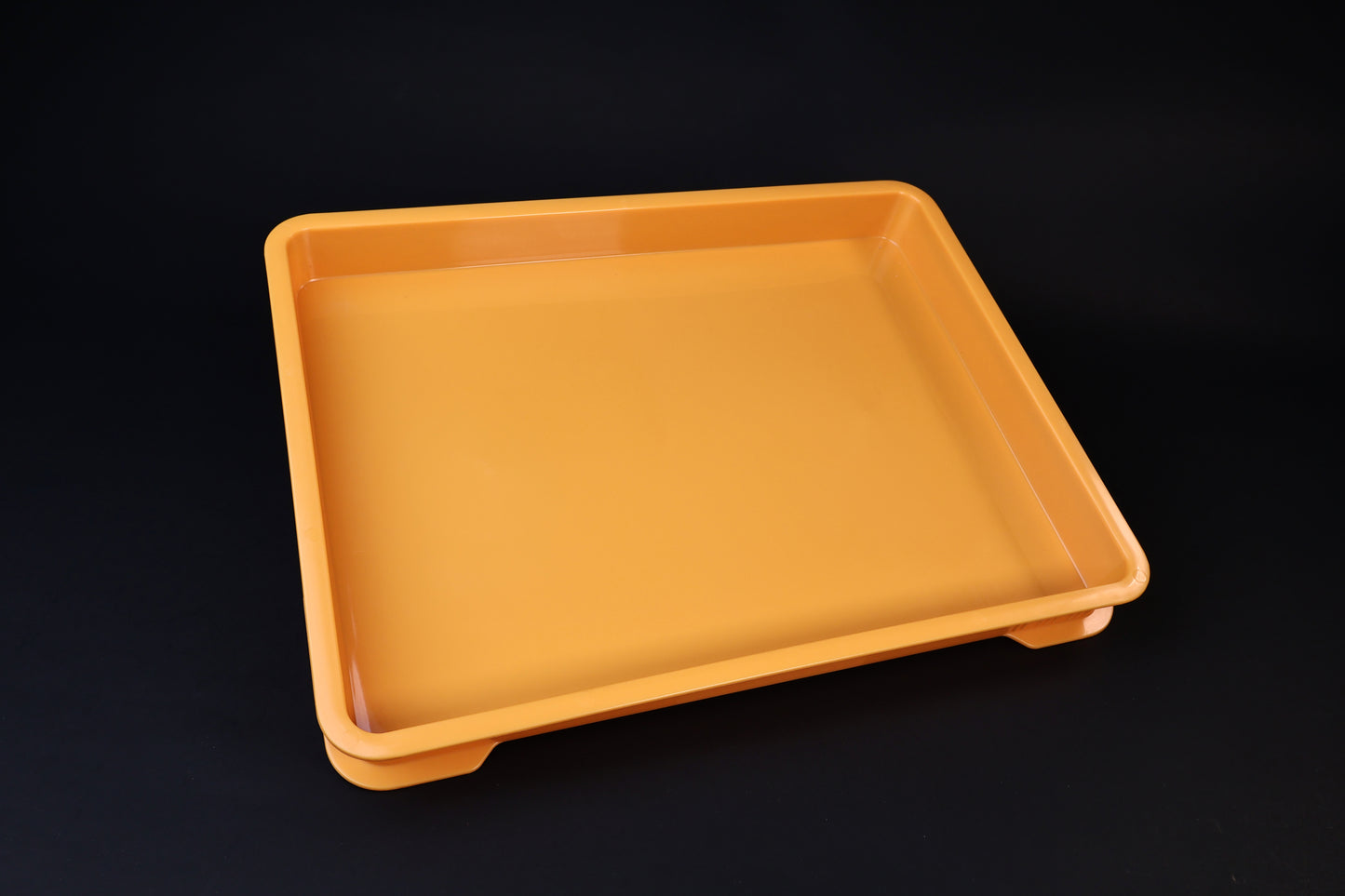 Sharpening Station Kit orange soaking tray, angled view showing interior basin and raised feet on black background