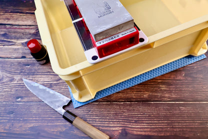 Sharpening station kit tall — stone holder in tray with whetstone, Japanese knife, and tsubaki oil in use