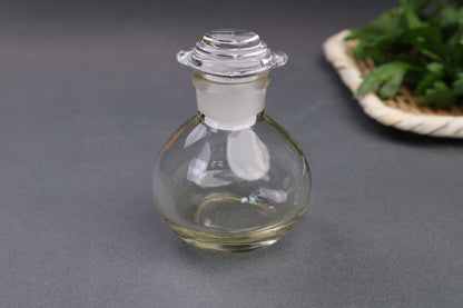 glass cruet japanese kitchenware short bulbous bottle spouted lid grey background