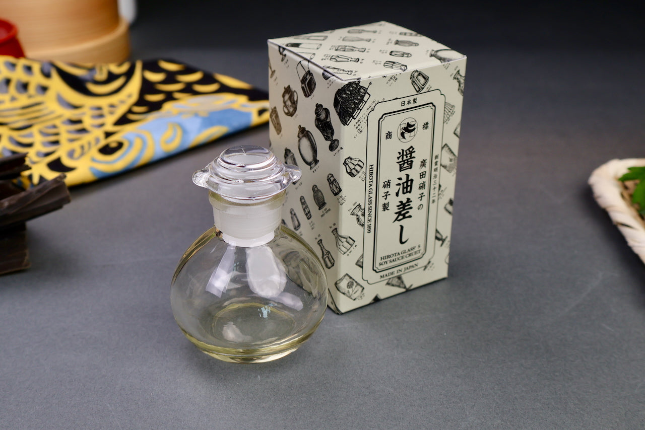 hirota glass Japan soy sauce cruet short bulbous bottle with spouted lid product box behind printed hiragana and animations grey background