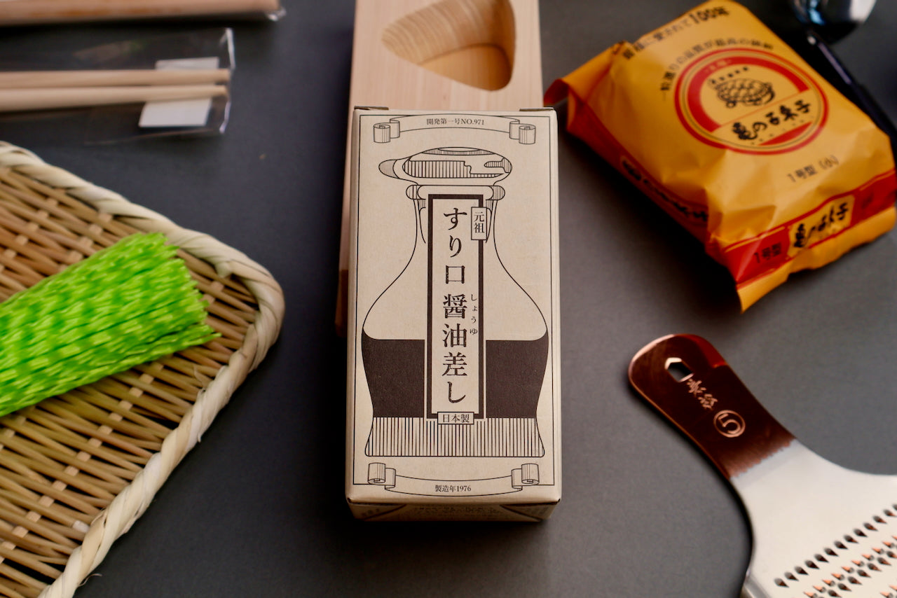 hirota glass original soy sauce cruet product box surrounded by bamboo plate Oroshigane grater Takashi brush grey background