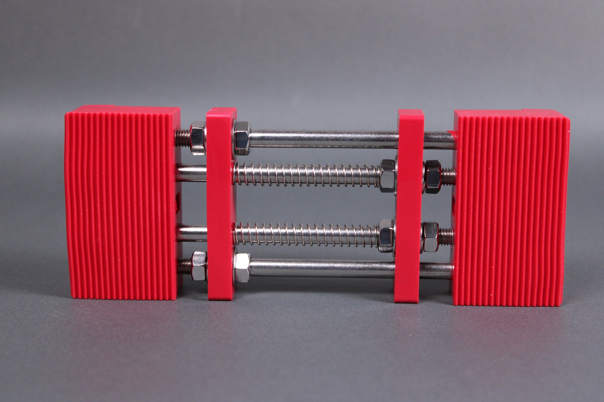 marie whetstone holder rectangular shape red in color with internal metal springs in grey background