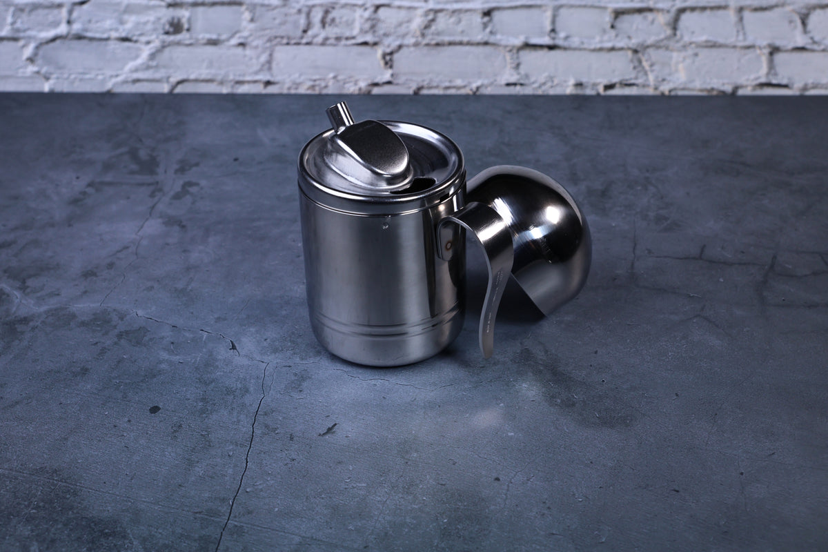 Stainless steel oil cruet small — side view with dome lid removed showing body and pour spout profile