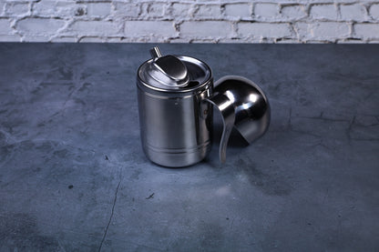 Stainless steel oil cruet small — side view with dome lid removed showing body and pour spout profile