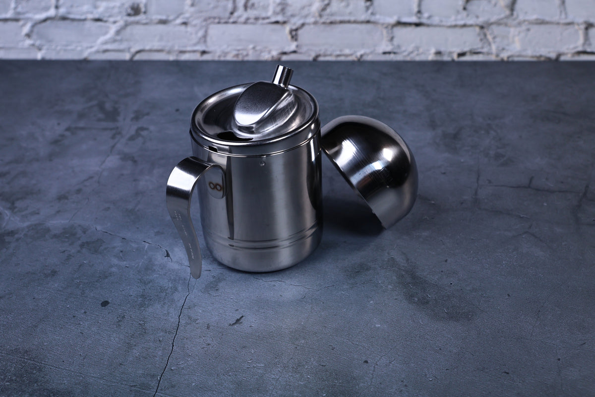 Stainless steel oil cruet small — front view with dome lid removed showing pour spout and open top
