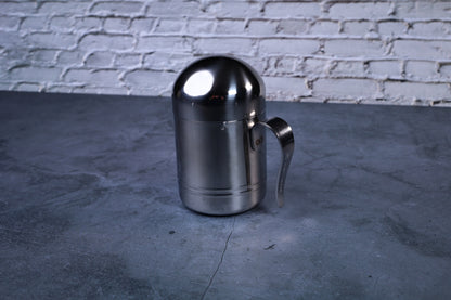 Stainless steel oil cruet small — full side view with dome lid on showing cylindrical body and handle