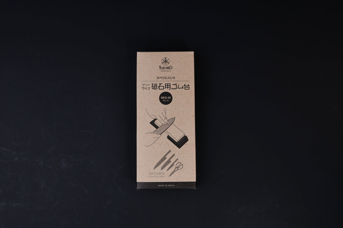 Suehiro rubber whetstone base SKG-42 packaging, kraft paper box with Japanese text and sharpening illustration